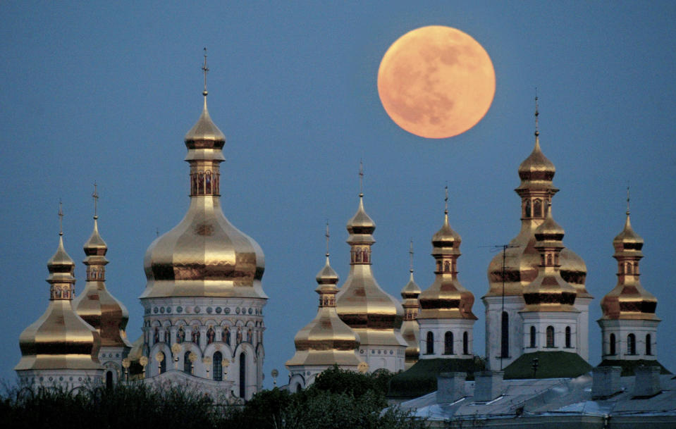 FILE - In this May 4, 2004 file photo, a full moon rises above the golden domes of the Orthodox Monastery of the Caves in Kiev, Ukraine. Tensions over the imminent formation of a Ukrainian Orthodox church independent of Moscow are raising fears that nationalists will try to seize Russian church properties.(AP Photo/Efrem Lukatsky, File)