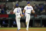 Texas Rangers' Josh Smith (47) and Nathaniel Lowe, right, celebrate their 5-2 win in a baseball game against the Oakland Athletics, Wednesday, July 13, 2022, in Arlington, Texas. (AP Photo/Tony Gutierrez)