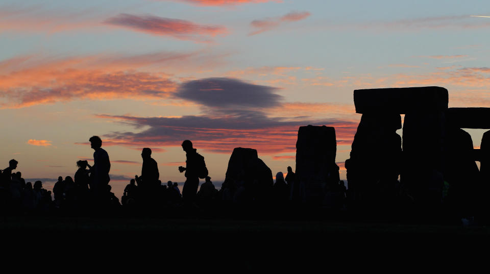 AMESBURY, ENGLAND - JUNE 20:  Solstice participants wait for the midsummer sun to rise over the megalithic monument of Stonehenge on June 20, 2010 on the edge of Salisbury Plain, west of Amesbury, England. (Photo by Matt Cardy/Getty Images)