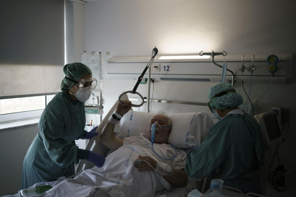 A COVID-19 patient receives treatment in the Hospital del Mar in Barcelona, Spain, Friday, July 9, 2021. (AP Photo/Felipe Dana)