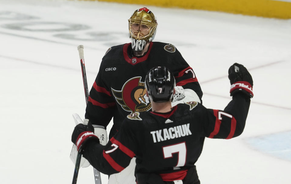 Ottawa Senators left wing Brady Tkachuk (7) races to congratulate goaltender Joonas Korpisalo, top, after they defeated the Montreal Canadiens in a shootout in NHL hockey game action in Ottawa, Ontario, Saturday, April 13, 2024. (Adrian Wyld/The Canadian Press via AP)