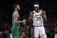 Los Angeles Lakers' Dwight Howard (39) celebrates after scoring next to Boston Celtics' Jayson Tatum during the first half of an NBA basketball game Sunday, Feb. 23, 2020, in Los Angeles. (AP Photo/Marcio Jose Sanchez)