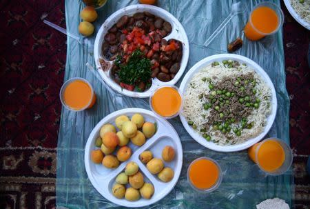 Iftar (breaking fast) meal plates are pictured during an Iftar organised by Adaleh Foundation, during the holy month of Ramadan in the rebel-held besieged town of Douma to the east of Damascus, Syria, June 20, 2017. REUTERS/Bassam Khabieh SEARCH "IFTAR ADALEH" FOR THIS STORY. SEARCH "WIDER IMAGE" FOR ALL STORIES.