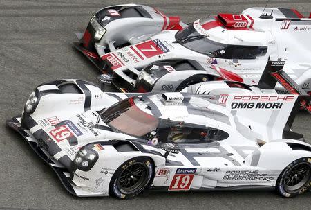 Nick Tandy of Britain drives his Porsche 919 Hybrid number 19 ahead the Audi R18 e-tron quattro number 7 driven by Marcel Fassler of Switzerland, during the Le Mans 24 Hours sportscar race in Le Mans, central France June 14, 2015. REUTERS/Regis Duvignau