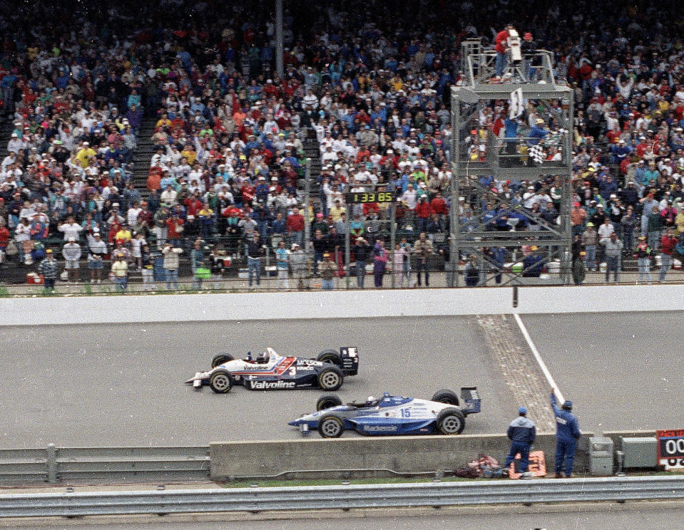 FILE - In this May 24, 1992, file photo, Al Unser Jr., top, wins the Indianapolis 500 auto race by less than a car length ahead of Scott Goodyear in the 76th running of the race at Indianapolis Motor Speedway in Indianapolis. The Associated Press has updated its survey of living Indianapolis 500 winners and their pick as the greatest race in the long history of the event. There are six races that received multiple votes, topped by Unser victory over Goodyear in 1992 — the closest Indy 500 in history. The others are Emerson Fittipaldi's win in 1989; Sam Hornish Junior's win in 2006; the 1982 battle between Rick Mears and Gordon Johncock; the 2011 race won by the late Dan Wheldon; and the 2014 thriller won by Ryan Hunter-Reay. (AP Photo/David Boe, File)