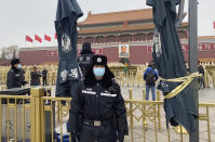 Chinese police officers stand on duty near Tiananmen Gate across from the Great Hall of the People where the annual congress meetings are expected to be held this week in Beijing Tuesday, March 2, 2021. China's legislature begins its annual meeting this week with economic growth and a further crackdown on political opponents in Hong Kong expected to be on the agenda. (AP Photo/Ng Han Guan)