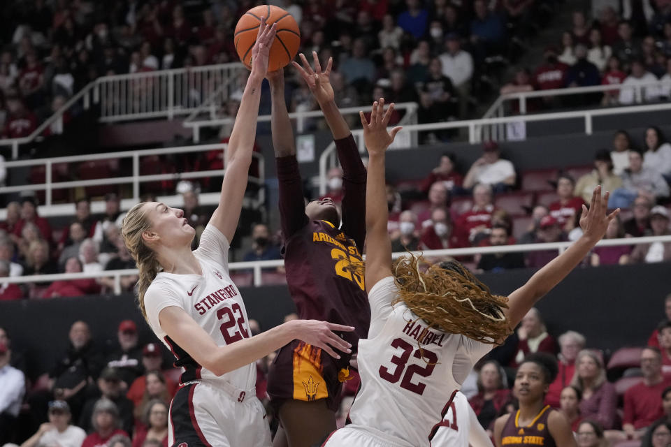 Stanford forward Cameron Brink, left, blocks a shot attempt by Arizona State guard Jalyn Brown, middle, as guard Jzaniya Harriel (32) defends during the first half of an NCAA college basketball game in Stanford, Calif., Sunday, Feb. 25, 2024. (AP Photo/Jeff Chiu)