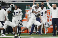 Penn State running back Nicholas Singleton (10) breaks up field during the first half of an NCAA college football game against Michigan State, Friday, Nov. 24, 2023, in Detroit. (AP Photo/Carlos Osorio)