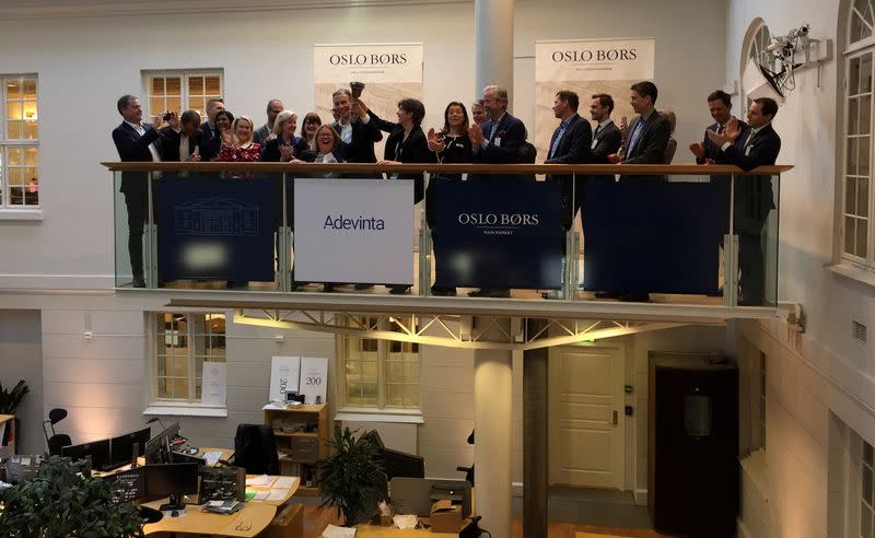 FILE PHOTO: Executives of Norwegian company Adevinta celebrate the firm’s first day of trading at the Oslo stock exchange