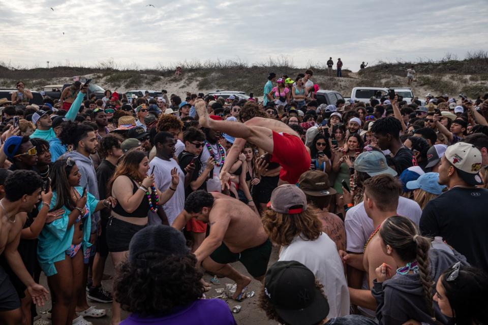 Hundreds of people gather on the beach near mile marker 32 for spring break on Wednesday, March 15, 2023, in Port Aransas, Texas. 