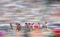 Athletes compete in their men's 5000m round 1 heat at the London 2012 Olympic Games at the Olympic Stadium August 8, 2012.