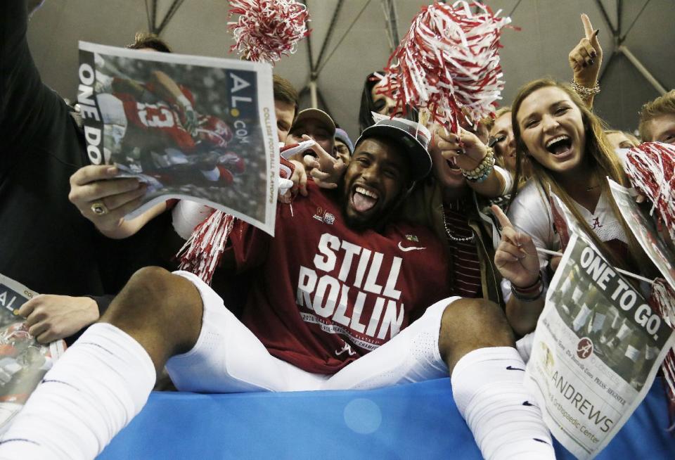 Alabama wide receiver T.J. Simmons celebrates with fans after the Peach Bowl NCAA college football playoff game between Alabama and Washington, Saturday, Dec. 31, 2016, in Atlanta. Alabama 24-7. (AP Photo/Skip Martin)