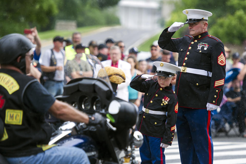 Marine Sgt. and child salute motorcyclists