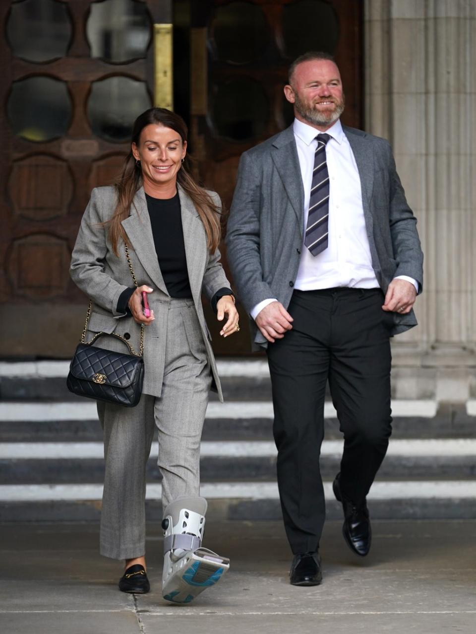 Coleen and Wayne Rooney leaving the Royal Courts Of Justice, London, as the high-profile libel battle between Rebekah Vardy and Coleen Rooney continues. Picture date: Monday May 16, 2022. (PA Wire)