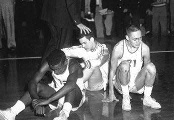 Dejected Muncie Central players react to Bobby Plump's last shot that beat them in the 1954 Indiana High School finals on March 20, 1954. From left are Jimmie Barnes, Phil Raisor and Leon Agullana.