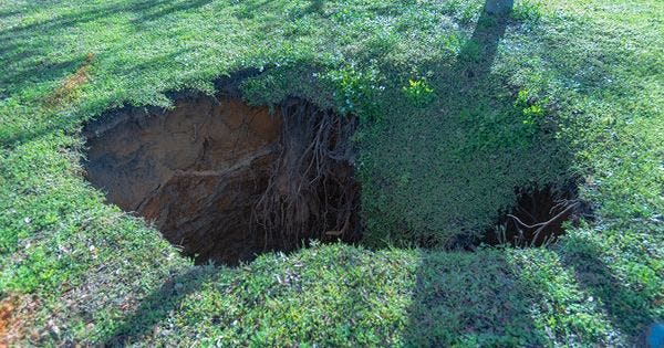 A sinkhole appeared in Highland City, Florida Saturday, Jan. 20, 2024. Officials say it was 15-feet wide and 60-feet deep when it occurred, and it expanded over the following days.