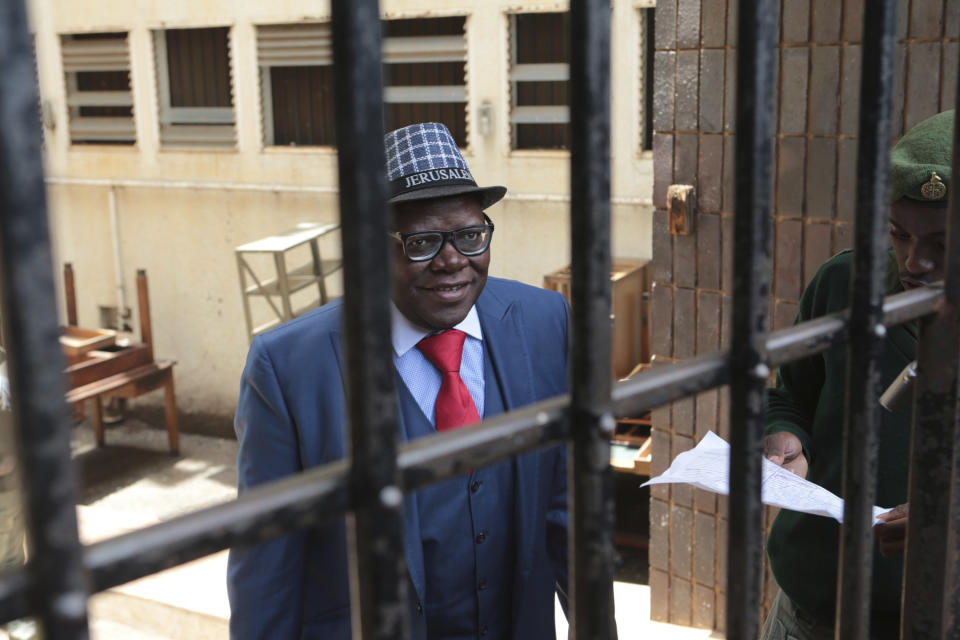 Tendai Biti, a prominent Zimbabwean politician, is seen before his release at the magistrates courts in Harare, Monday, Feb, 18, 2019. A Zimbabwean court has convicted prominent opposition politician Tendai Biti for announcing that his party's leader won disputed elections held in July. Biti was on trial for "unofficial and false declaration of results." (AP Photo/Tsvangirayi Mukwazhi)