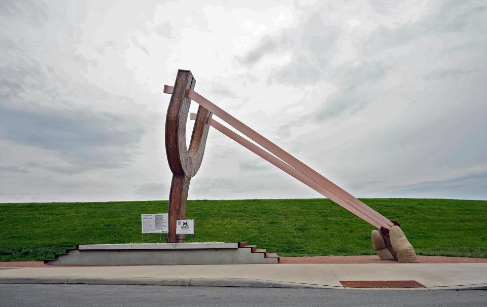 Columbus developer Casto erected the 20-foot-long slingshot at the corner of Sullivant Avenue and Lucas Street, next to Casto's River & Rich development in Columbus, on May 18. Tailor-made for photos, the sculpture was designed by Franklinton artist Andrew Lundberg, who runs Lundberg Industrial Arts.