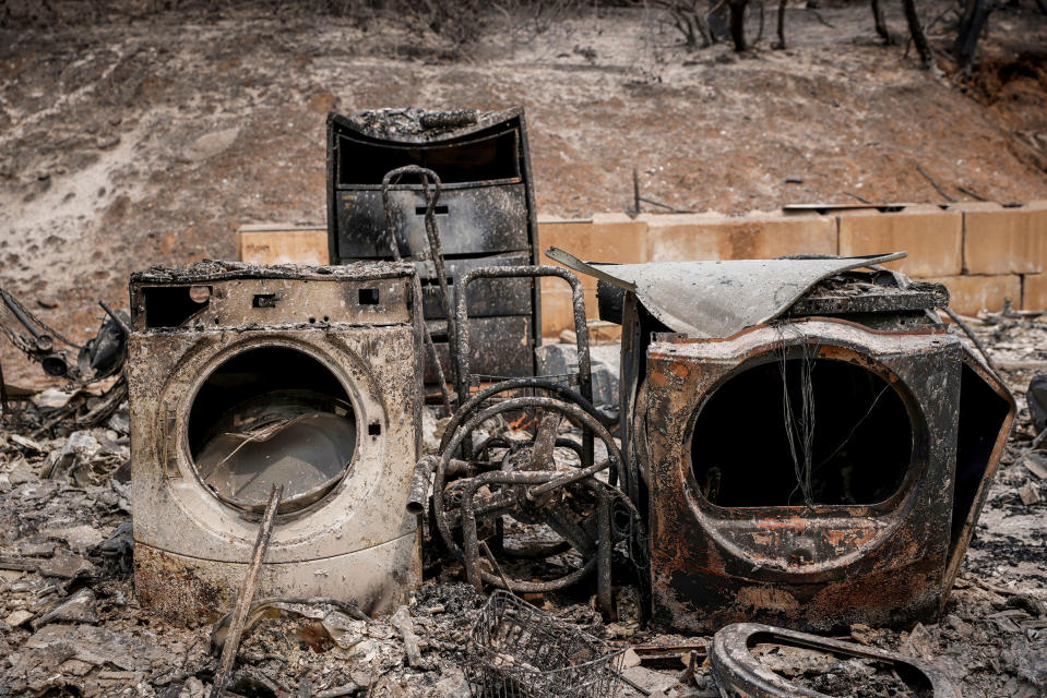 Debris from a burned home is seen after flames from the Oak Fire swept through Triangle Road in Mariposa County on July 26.<span class="copyright">Brontë Wittpenn—San Francisco Chronicle/AP</span>