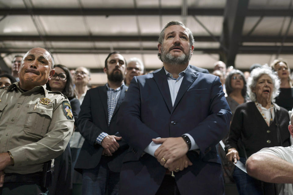 FILE - U.S. Sen. Ted Cruz, R-Texas, attends a prayer vigil with Uvalde County Sheriff Ruben Nolasco, left, in Uvalde, Texas, on May 25, 2022. Republicans including Texas Sen. Ted Cruz have called for investments in school security. Some experts say those measures only go so far and can sometimes backfire. (AP Photo/Jae C. Hong, File)