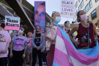 People protest outside the Netflix building on Vine Street in the Hollywood section of Los Angeles, Wednesday, Oct. 20, 2021. Critics and supporters of Dave Chappelle's Netflix special and its anti-transgender comments gathered outside the company's offices Wednesday, Oct. 20, 2021, with "Trans Lives Matter" and "Free Speech is a Right" among their competing messages. (AP Photo/Damian Dovarganes)