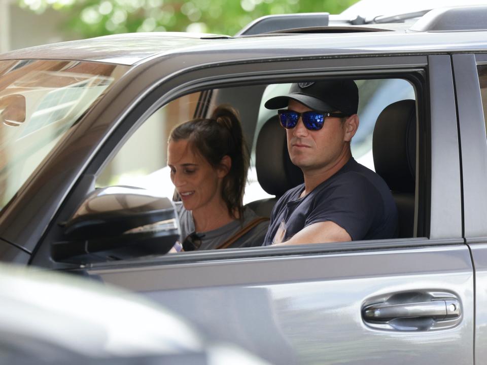 Joey Levin, CEO of IAC, drives in a car with a passenger at Sun Valley conference