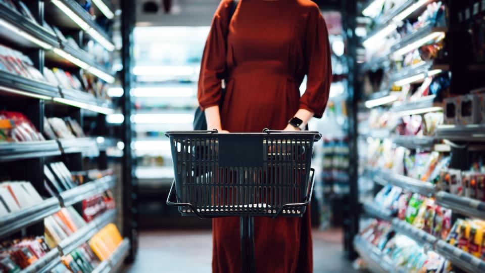 Woman in red dress shops at the grocery store