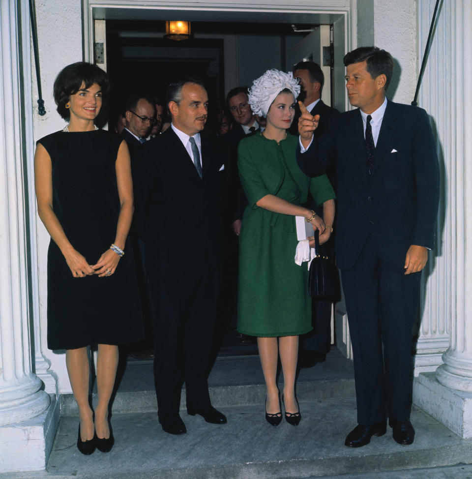 President and Mrs.. Kennedy pose with Prince Rainier and Princess Grace at a reception at the White House.