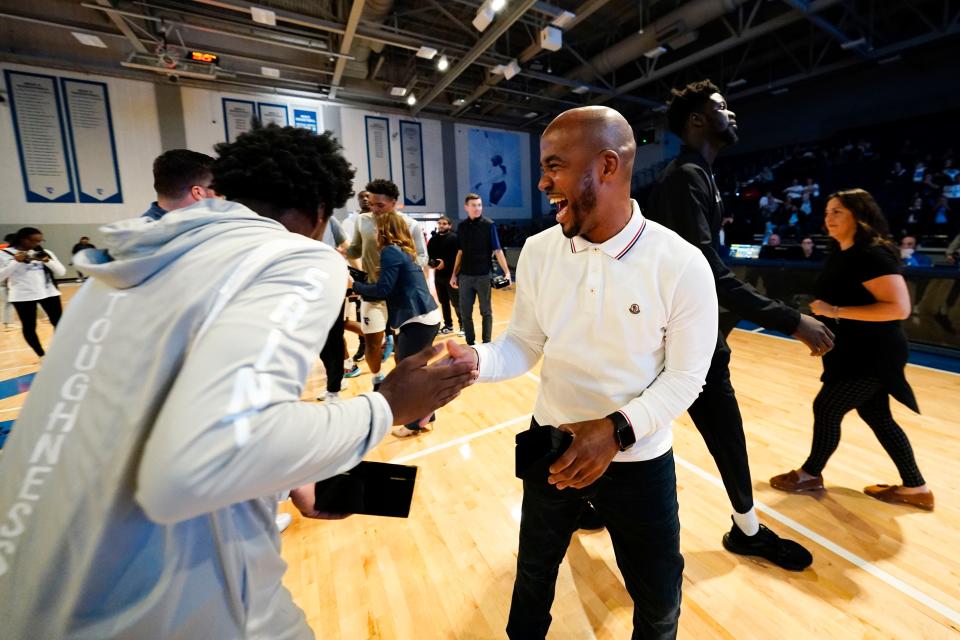 Saint Peter's former head basketball coach Shaheen Holloway, right, shakes hands with a player after the ring ceremony. The Saint Peter's men's basketball team was honored during a pregame ceremony at Yanitelli Center on Monday, Nov. 7, 2022, in Jersey City.