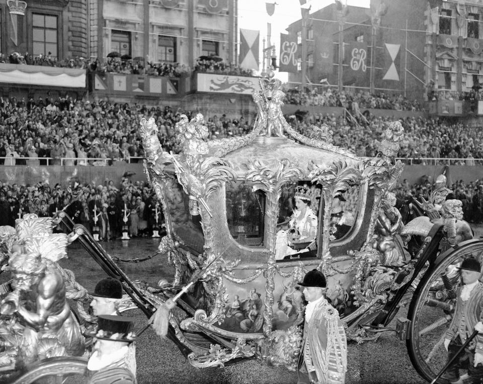 The Coronation of Queen Elizabeth II was the ceremony in which the newly ascended monarch, Elizabeth II, was crowned Queen of the United Kingdom, Canada, Australia, New Zealand, South Africa, Ceylon, and Pakistan, as well as taking on the role of Head of the Commonwealth. (Picture) Holding the Orb, smiling Queen leaves Westminster Abbey in state coach, 2nd June 1953. (Photo by Bela Zola/Mirrorpix/Getty Images)