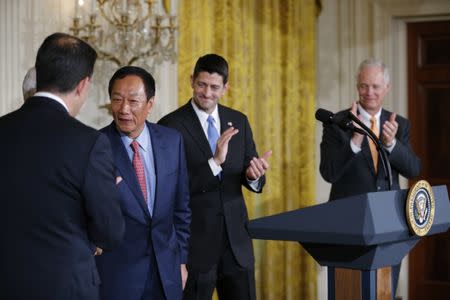 Foxconn Chairman Terry Gou (2ndL) greets Wisconsin Governor Scott Walker (L) as House Speaker Paul Ryan and Snator RonJhnson (R), both of Wisconsin, applaud during a White House event where the Taiwanese electronics manufacturer Foxconn announced plans to build a $10 billion dollar LCD display panel screen plant in Wisconsin, in Washington, U.S., July 26, 2017. REUTERS/Jonathan Ernst