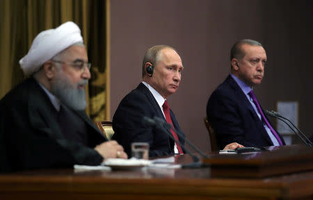 Iran's President Hassan Rouhani together with his counterparts, Russia's Vladimir Putin and Turkey's Tayyip Erdogan, attend a joint news conference following their meeting in Sochi, Russia November 22, 2017. Sputnik/Mikhail Klimentyev/Kremlin via REUTERS ATTENTION EDITORS - THIS IMAGE WAS PROVIDED BY A THIRD PARTY.