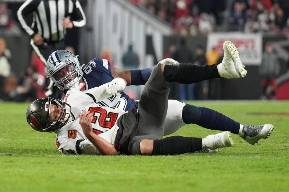 Tampa Bay Buccaneers quarterback Tom Brady (12) is hit after a throw by Dallas Cowboys defensive tackle Neville Gallimore (96) during an NFL wild-card football game, Monday, Jan. 16, 2023, in Tampa, Fla.
