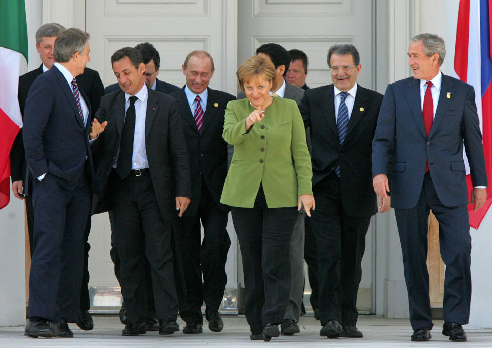 FILE - In this Thursday, June 7, 2007 file photo, German Chancellor Angela Merkel, center, U.S. President George Bush, Italian Premier Romano Prodi, Japanese Premier Shinzo Abe, Russian President Vladimir Putin, French President Nicolas Sarkozy, EU Commission President Jose Manuel Barroso, British Premier Tony Blair and Canadian Premier Stephen Harper walk to their family photo during the G8 summit in Heiligendamm, Germany. Merkel has also been lauded as an impressive role model for girls both at home and around the globe for standing up to male leaders. (AP Photo/Michael Probst, File)