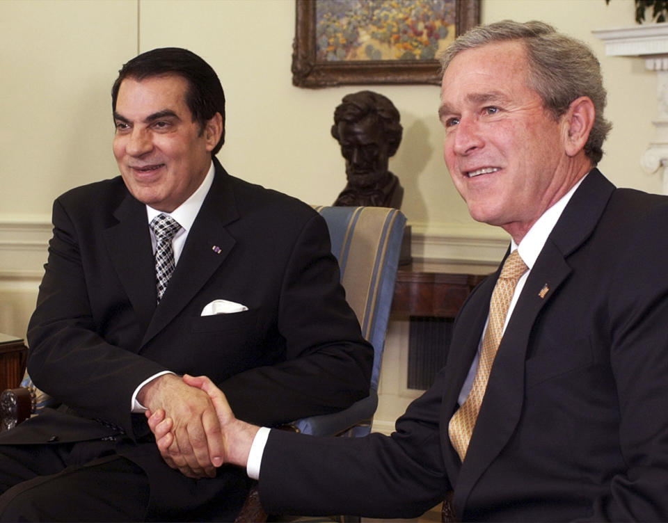 FILE - In this Feb. 18, 2004 file photo, President Bush shakes hands with Tunisian President Zine El Abidine Ben Ali in the Oval Office of the White House in Washington. Tunisia's autocratic ruler Zine El Abidine Ben Ali, toppled in 2011, died in exile in Saudi Arabia. (AP Photo/Susan Walsh, File)