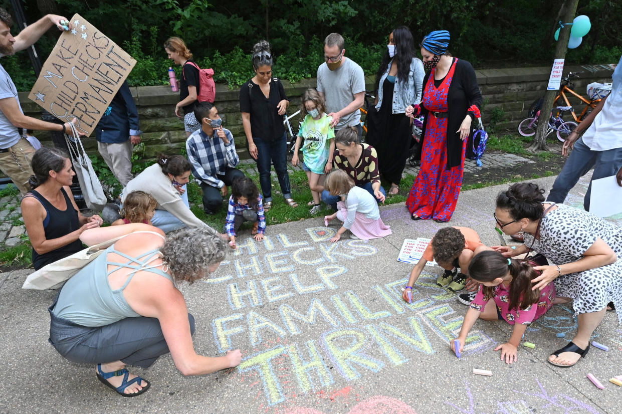 BROOKLYN, NEW YORK - JULY 12: Parents and children celebrate new monthly Child Tax Credit payments and urge congress to make them permanent outside Senator Schumer's home on July 12, 2021 in Brooklyn, New York. (Photo by Bryan Bedder/Getty Images for ParentsTogether)