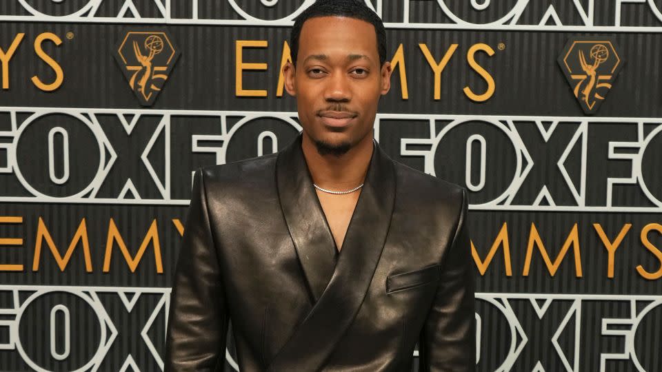 Abbott Elementary’s Tyler James Williams wore a black leather Dolce & Gabbana suit with leather derby shoes and diamond jewelry. - Jordan Strauss/Invision/AP