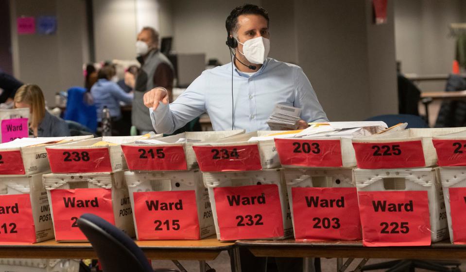 Workers process Election Day ballots at the City of Milwaukee Central Count Facility in Milwaukee.