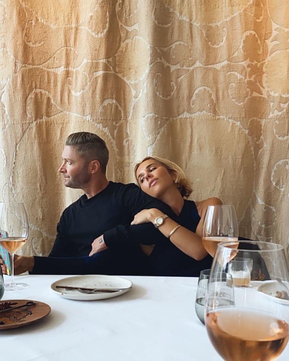 Fashion designer Pip Edwards and Aussie cricketer Michael Clarke sitting at a dinner table in a up scale restaurant