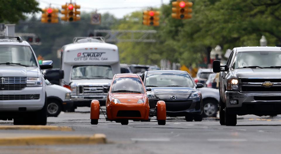Since early 2013, Elio Motors has accumulated more than 65,000 deposits for its three-wheeled, two-seat, 84 mpg vehicle. But it has failed to deliver any vehicles. A prototype is seen here on the streets of Royal Oak, Michigan, in 2014.