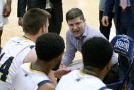 In this Thursday, Feb. 27, 2020 photo, Merrimack College head coach Joe Gallo directs his team during a timeout in the second half of an NCAA college basketball game against Central Connecticut in North Andover, Mass. The Warriors have been one of the biggest surprises in college basketball, winning more games than any other first-year Division I program in history. (AP Photo/Mary Schwalm)