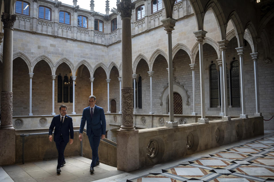 Spanish Prime Minister Pedro Sanchez, right, walks with Catalonia's President Pere Aragones during a meeting in Barcelona, Spain, Thursday, Dec. 21, 2023. Sanchez and Aragones meet in the first encounter since an amnesty for Catalan separatists was announced earlier this year. (AP Photo/Emilio Morenatti)