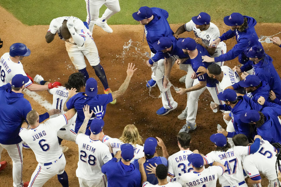 Texas Rangers' Adolis Garcia celebrates after hitting a game-winning home run against the Arizona Diamondbacks during the 11th inning in Game 1 of the baseball World Series Friday, Oct. 27, 2023, in Arlington, Texas. The Rangers won 6-5. (AP Photo/Godofredo A. Vásquez)