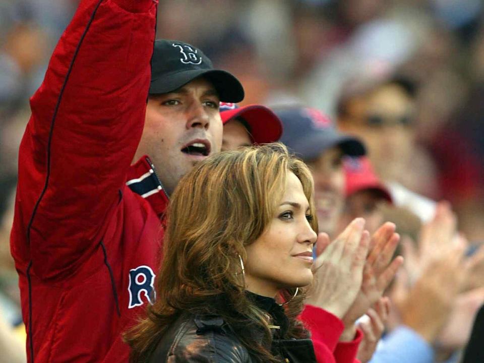 Actress/singer Jennifer Lopez and boyfriend, actor Ben Affleck watch the New York Yankees take on the Boston Red Sox during Game 3 of the 2003 American League Championship Series on October 11, 2003 at Fenway Park in Boston, Massachusettes. (Photo by Ezra Shaw/Getty Images)