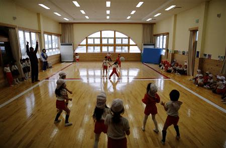 Children play dodge ball in a playroom at the Emporium kindergarten in Koriyama, west of the tsunami-crippled Fukushima Daiichi nuclear power plant, Fukushima prefecture February 28, 2014. REUTERS/Toru Hanai