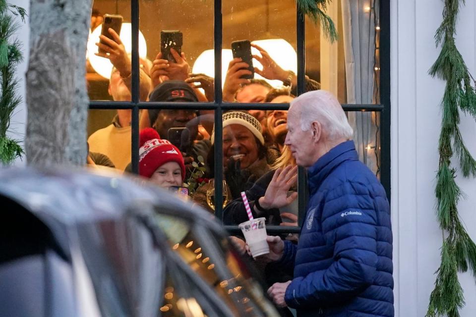 Locals react as Biden walks past while visiting shops with family in Nantucket (AP)