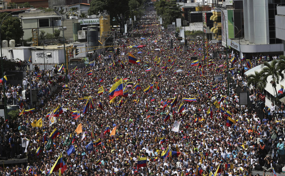 FILE - In this Feb. 2, 2019 file photo, anti-government protesters take part in a nationwide demonstration demanding the resignation of President Nicolas Maduro, in Caracas, Venezuela. With Venezuela mired in a political and economic crisis, roughly 4.5 million people have left the nation, figures that rival mass migration from war-torn Syria. (AP Photo/Rodrigo Abd, File)