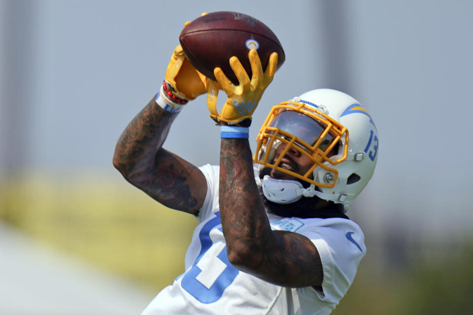 FILE - In this Aug. 19, 2020, file photo, Los Angeles Chargers wide receiver Keenan Allen makes a catch during NFL football camp in Costa Mesa, Calif. Allen has signed a four-year extension with the Chargers that will make him the league's second-highest paid receiver in average money. A person familiar with the deal says it is worth $80.1 million with $50 million guaranteed. The person spoke to The Associated Press on condition of anonymity because financial terms were not released by the Chargers on Saturday, Sept. 5, 2020. (AP Photo/Jae C. Hong, File)