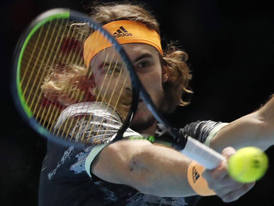 Stefanos Tsitsipas of Greece plays a return to Spain's Rafael Nadal during their ATP World Tours Finals singles tennis match at the O2 Arena in London, Friday, Nov. 15, 2019. (AP Photo/Alastair Grant)