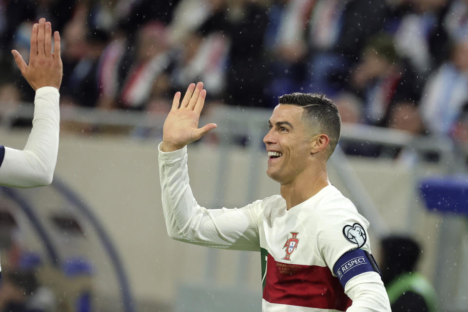 Portugal's Cristiano Ronaldo is congratulated after scoring the opening goal during the Euro 2024 group J qualifying soccer match between Luxembourg and Portugal at the Stade de Luxembourg in Luxembourg, Sunday, March 26, 2023. (AP Photo/Olivier Matthys)